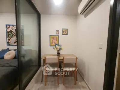 Cozy dining area with modern decor and air conditioning in a stylish apartment.