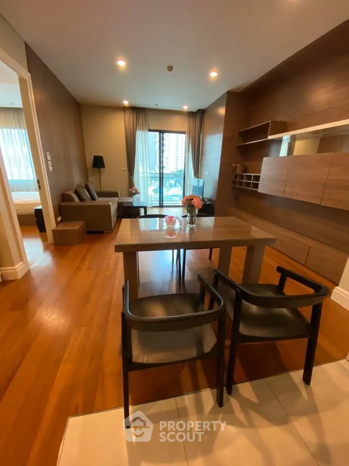 Modern living room with wooden flooring and stylish furniture in a high-rise apartment.