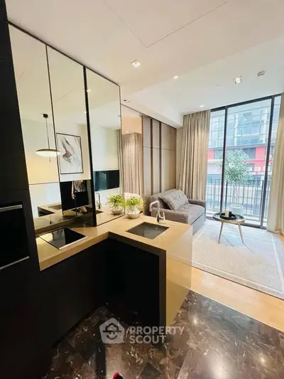 Modern open-layout kitchen and living room with sleek design and large windows.