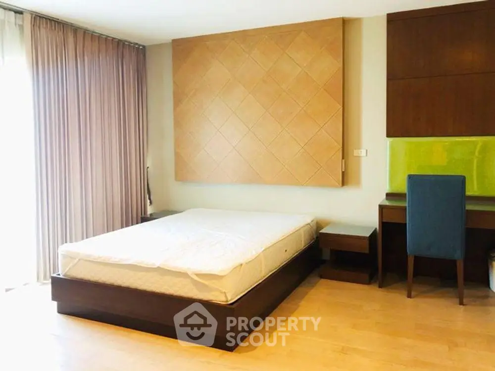 Spacious bedroom with modern decor and natural light