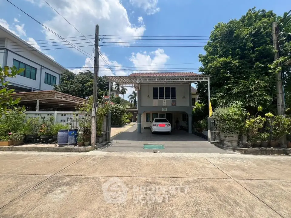Charming suburban house with carport and lush greenery, perfect for family living.