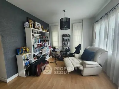 Cozy study room with bookshelves and comfortable seating, perfect for relaxation and work.