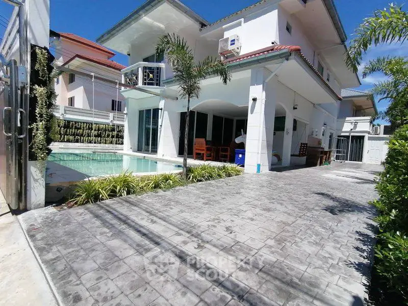 Stunning modern villa with pool and spacious driveway in a serene neighborhood.