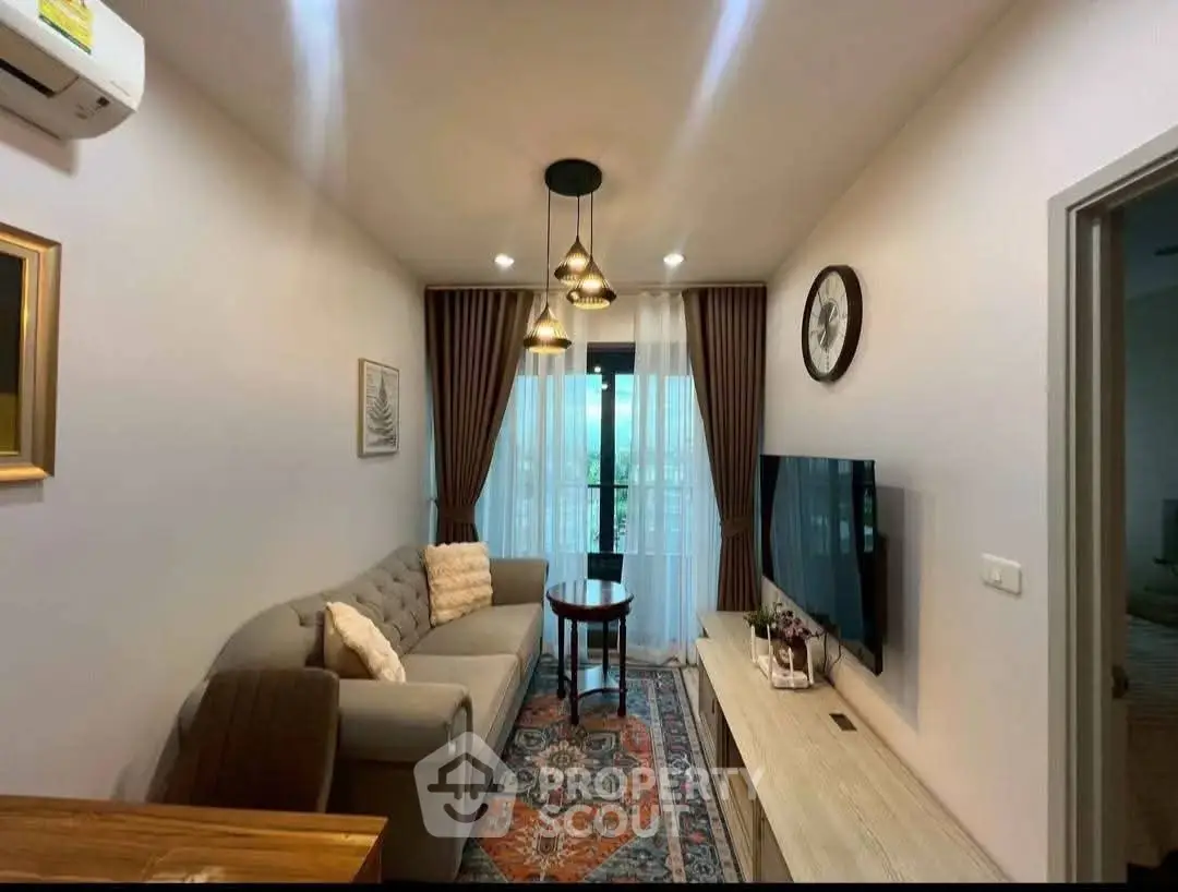 Cozy living room with modern decor, plush sofa, and wall-mounted TV, perfect for relaxation.