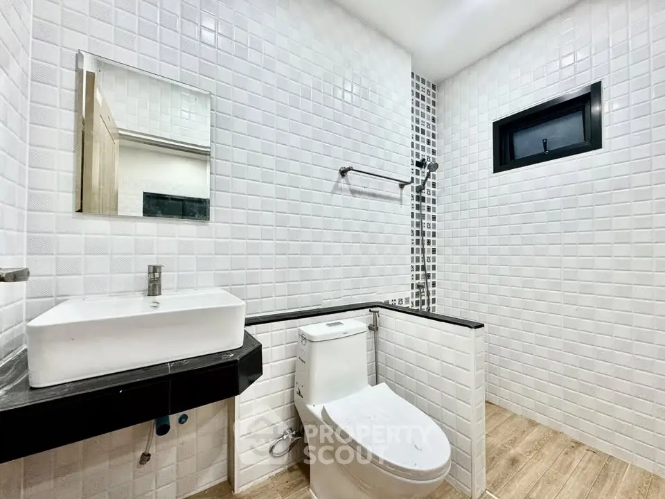 Modern bathroom with sleek white tiles and contemporary fixtures