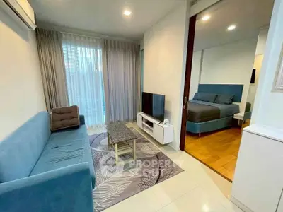 Modern living room with cozy sofa and adjacent bedroom in stylish apartment.