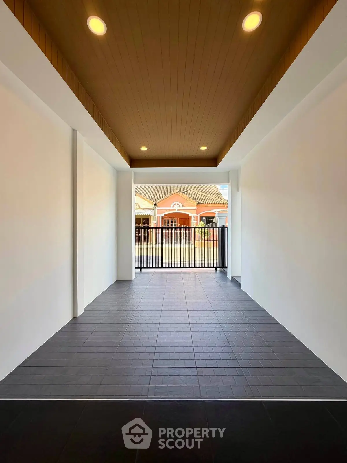 Spacious modern entrance with elegant ceiling lights and tiled flooring