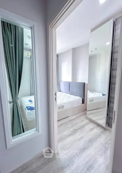 Modern bedroom with mirrored wardrobe and stylish decor in a bright apartment.
