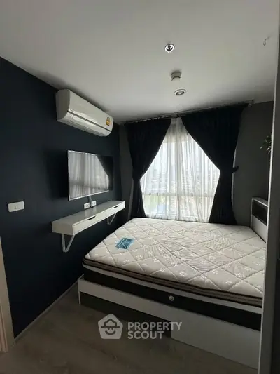 Modern bedroom with large window, stylish decor, and air conditioning unit.
