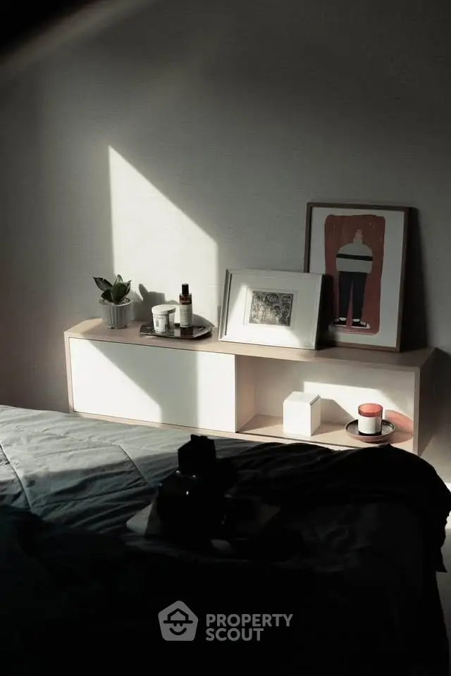 Cozy bedroom corner with stylish decor and soft lighting, perfect for relaxation.