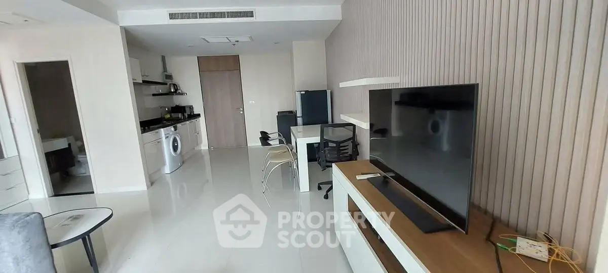 Modern living room with sleek furniture and integrated kitchen appliances