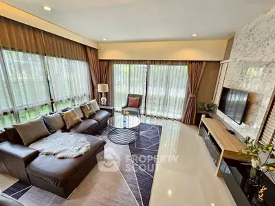 Luxurious living room with modern decor and large windows offering natural light.