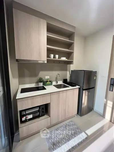 Modern compact kitchen with sleek appliances and stylish cabinetry