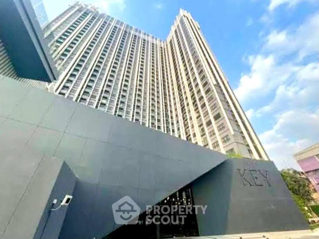 Modern high-rise building with sleek architecture and clear blue sky