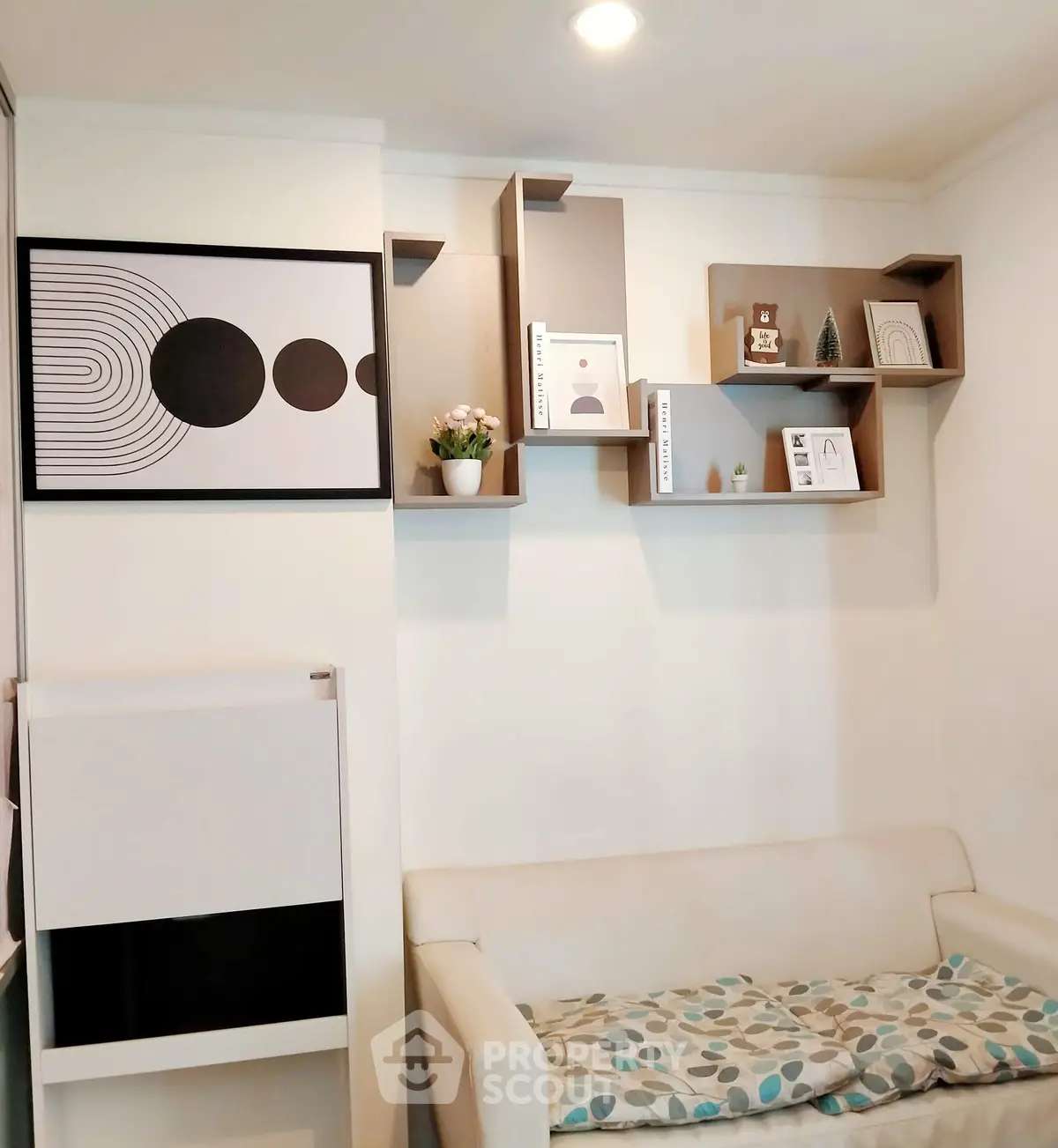 Modern living room with stylish wall shelves and cozy seating area