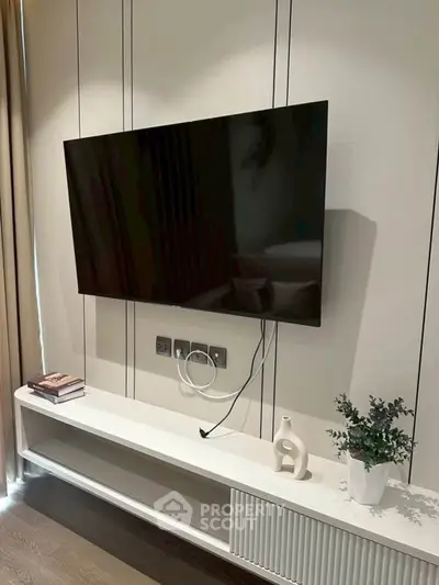 Modern living room with wall-mounted TV and stylish decor