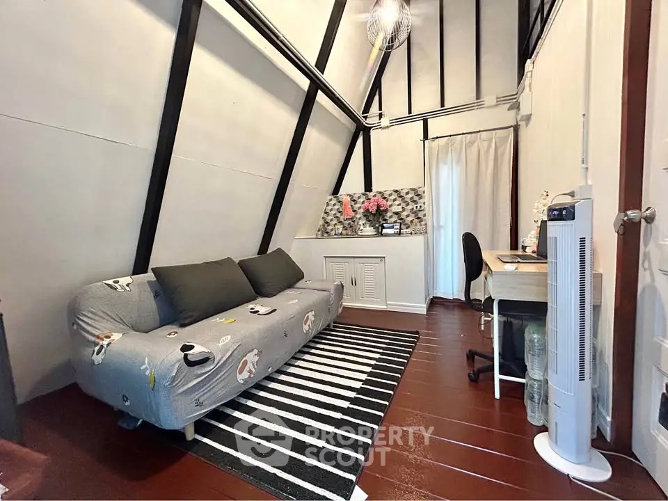 Cozy attic living room with stylish decor and comfortable seating