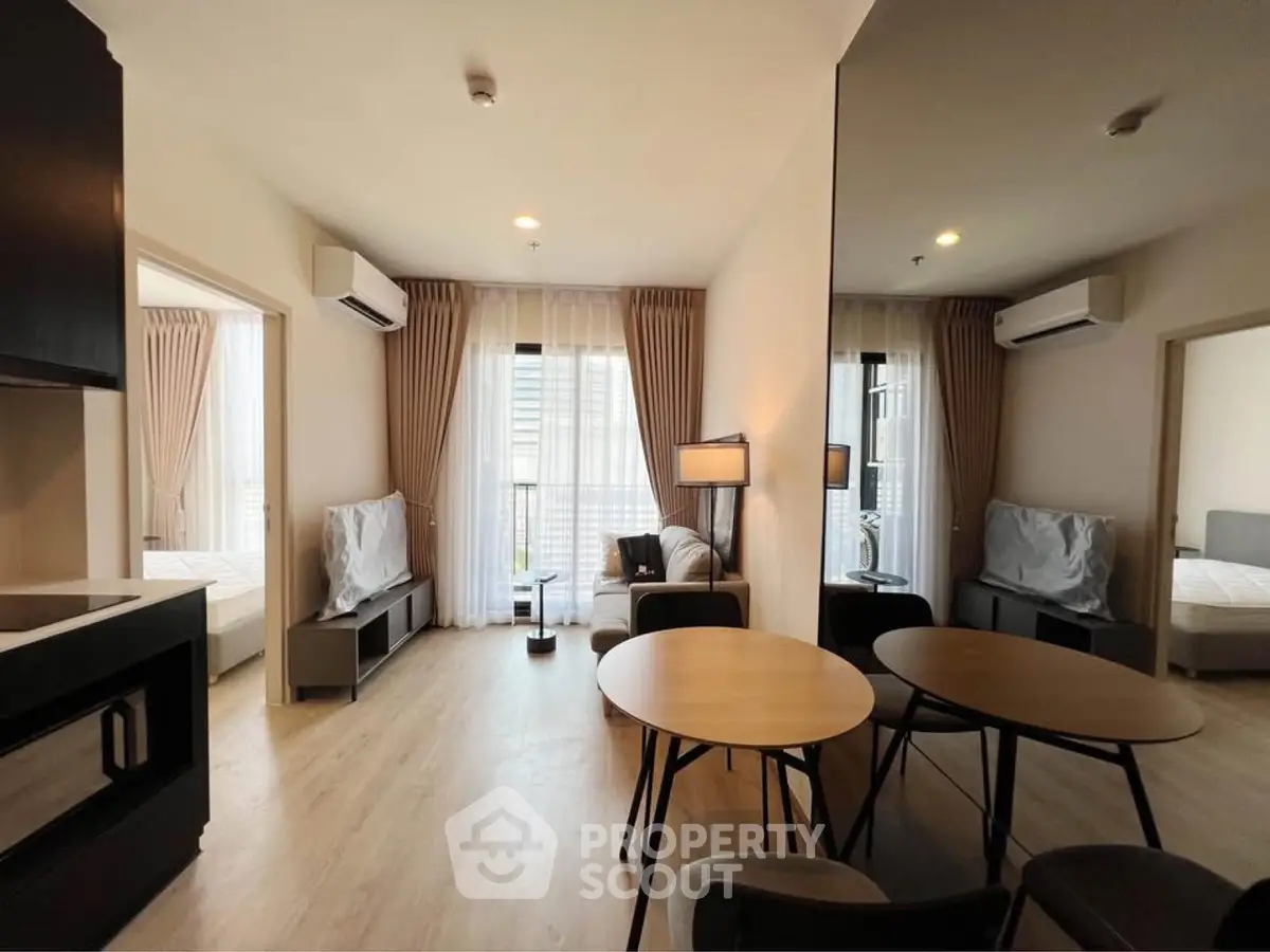Modern living room with open layout, stylish furniture, and natural light, perfect for urban living.