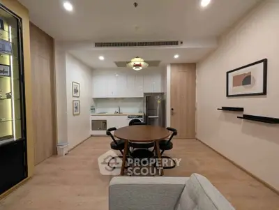 Modern open-layout kitchen and dining area with stylish furniture and contemporary decor.