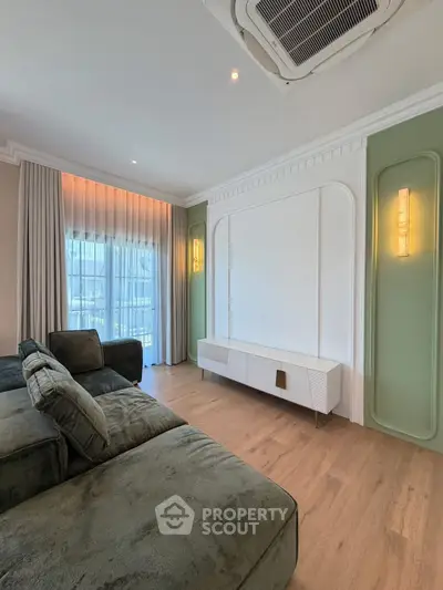 Luxurious living room with elegant decor and large windows for natural light.