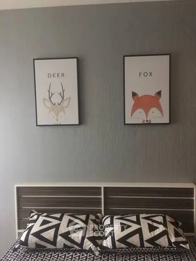 Stylish bedroom with modern decor and animal-themed artwork above bed.