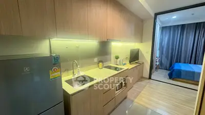 Modern kitchen with sleek cabinetry and stainless steel appliances in a stylish apartment.