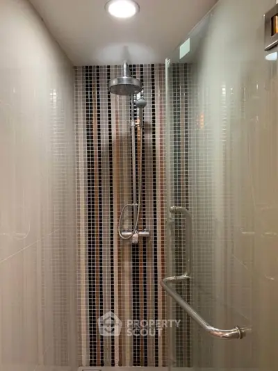 Modern bathroom shower with sleek tile design and chrome fixtures