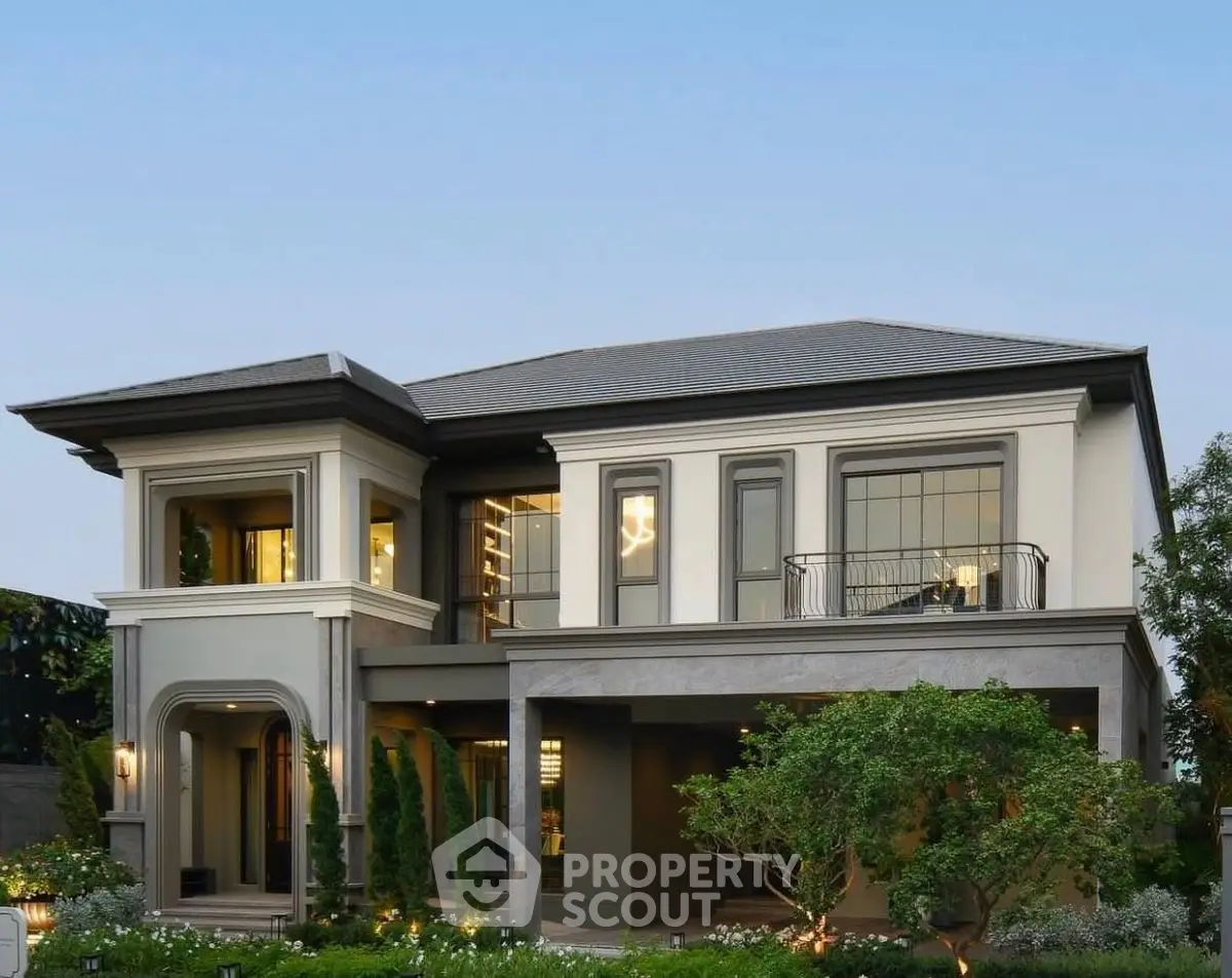 Luxurious two-story modern home with elegant facade and lush landscaping