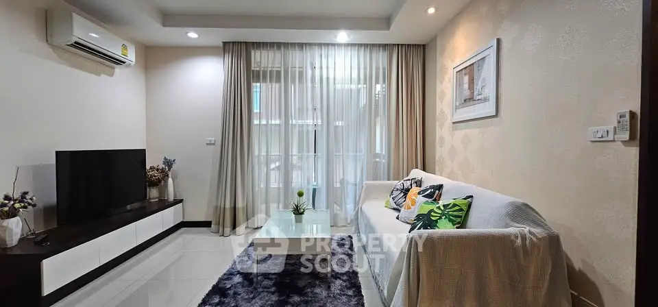 Stylish living room with modern decor, cozy sofa, and large window for natural light.