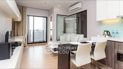Modern open-plan living room with sleek furniture and city view balcony.