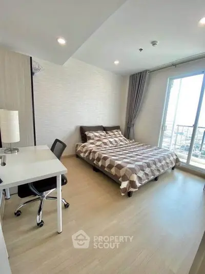 Modern bedroom with large window and stylish decor in a high-rise apartment.