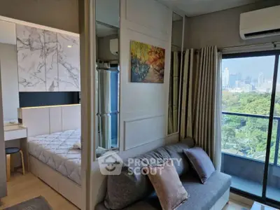 Modern apartment interior with city view, featuring cozy living area and stylish bedroom.