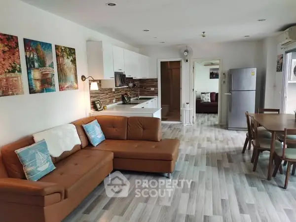 Spacious open-plan living room with modern kitchen and stylish decor.