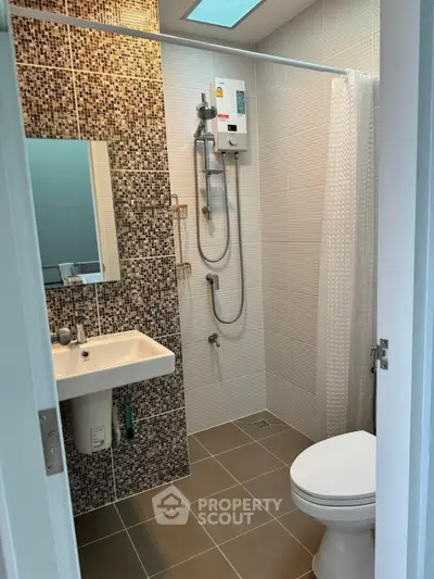 Modern bathroom with mosaic tiles and shower in stylish apartment