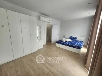 Spacious bedroom with modern furnishings and natural light