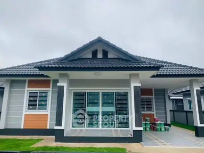 Modern single-story house with tiled roof and spacious front yard