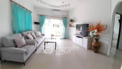 Spacious living room with modern decor and natural light