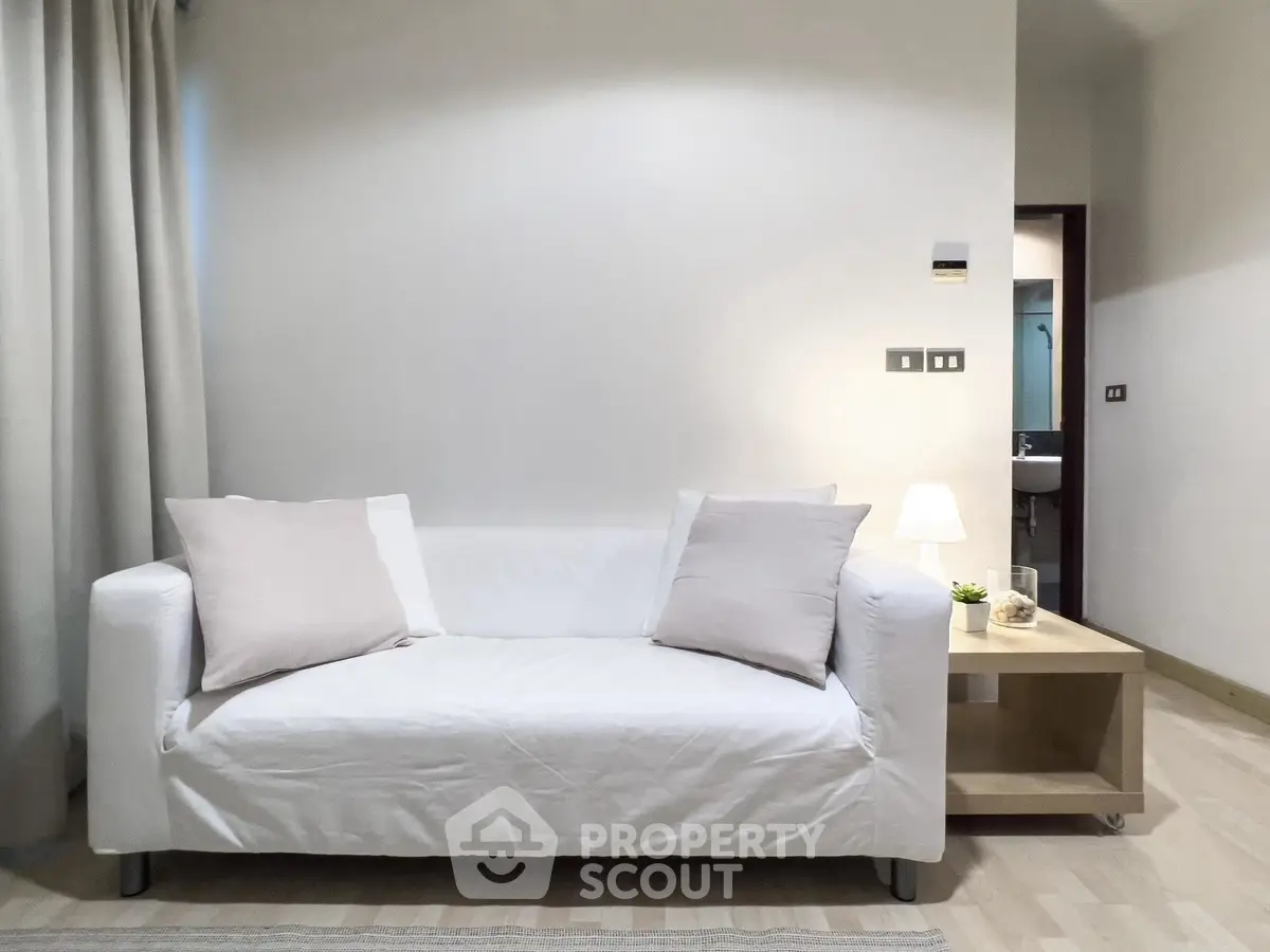 Modern living room with white sofa and minimalist decor
