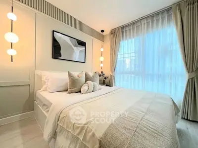 Luxurious bedroom with elegant decor and large window for natural light.