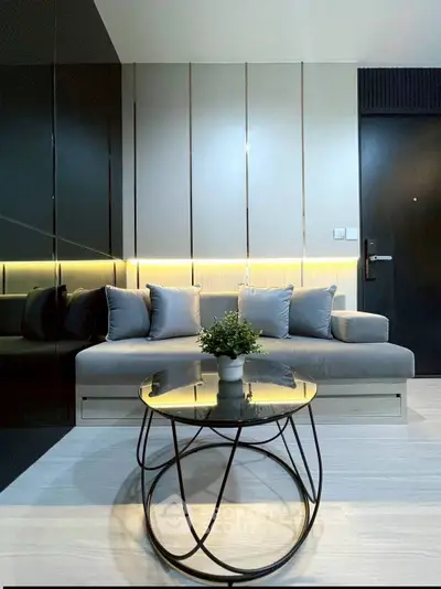 Modern living room with sleek design and cozy seating area, perfect for relaxation.