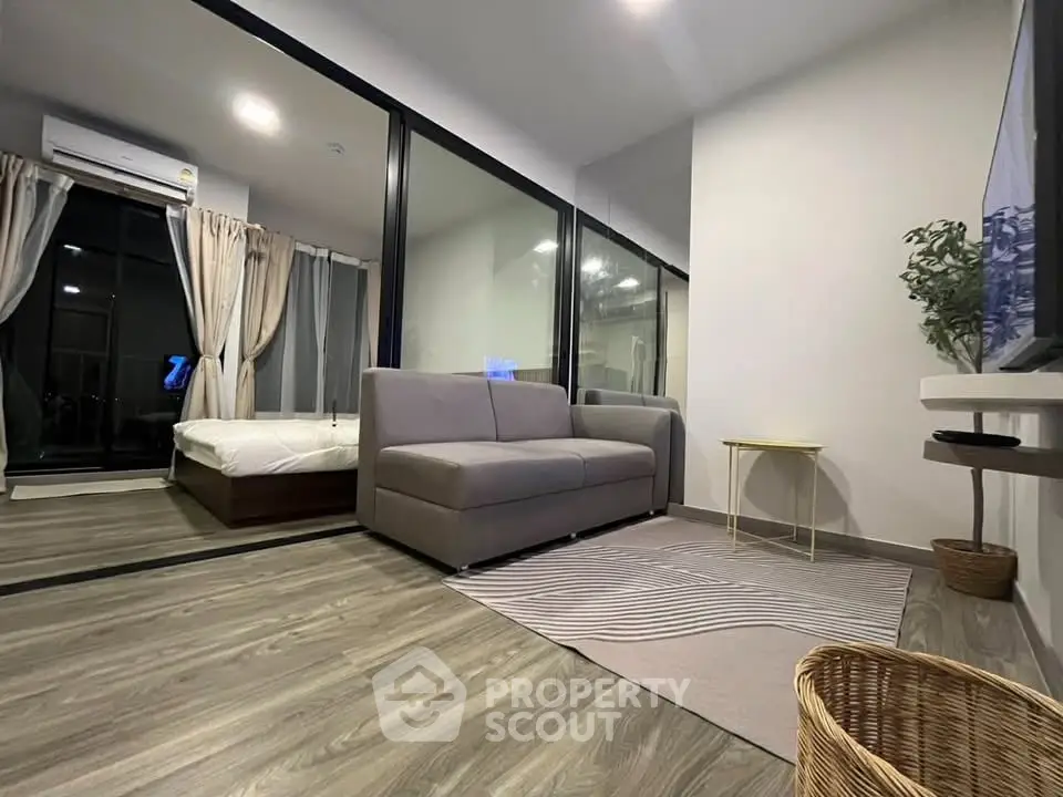 Modern living room with sleek design and large windows in a stylish apartment.