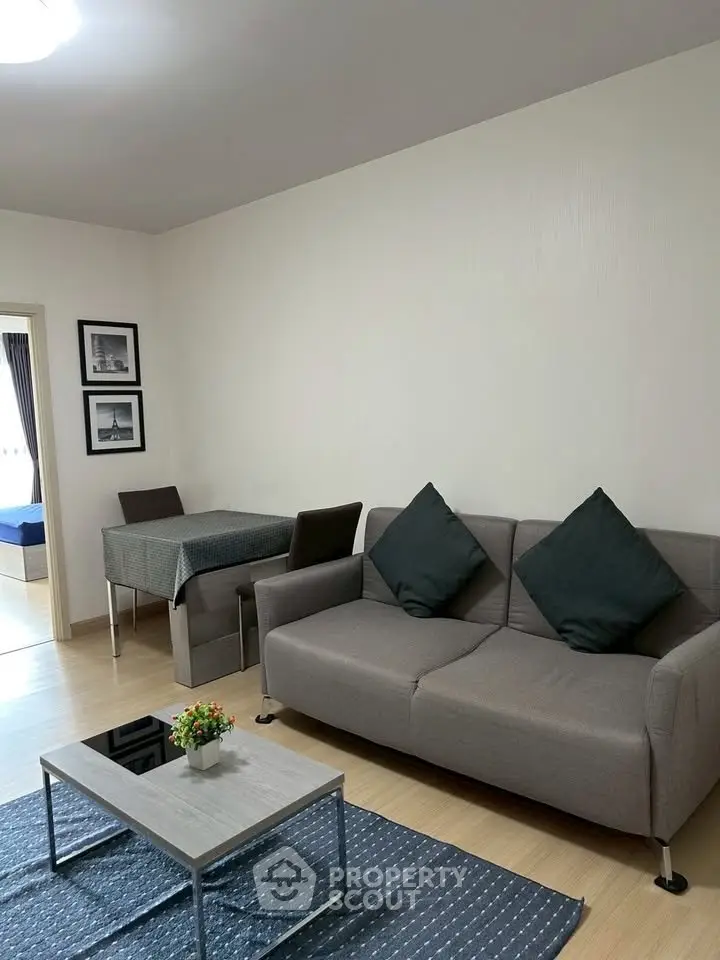 Modern living room with stylish sofa and dining area in open layout apartment.