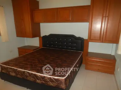 Spacious bedroom with elegant wooden cabinetry and a comfortable bed, perfect for restful nights.