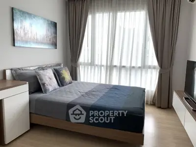 Modern bedroom with stylish decor and large window for natural light