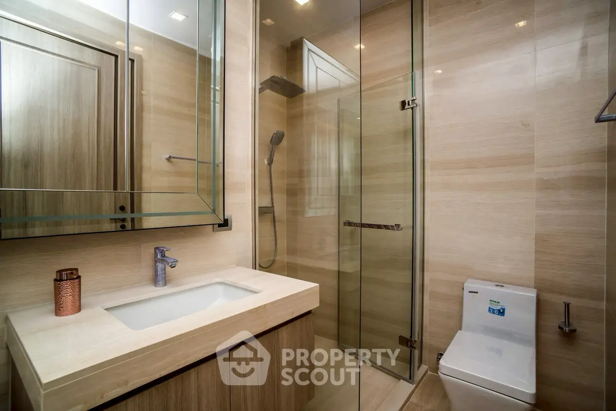 Luxurious modern bathroom with glass shower and elegant fixtures