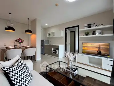 Modern open-plan living room with stylish decor and kitchen area, perfect for urban living.