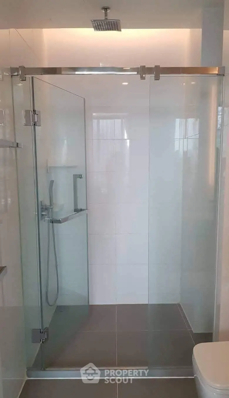 Modern bathroom with glass shower enclosure and sleek fixtures
