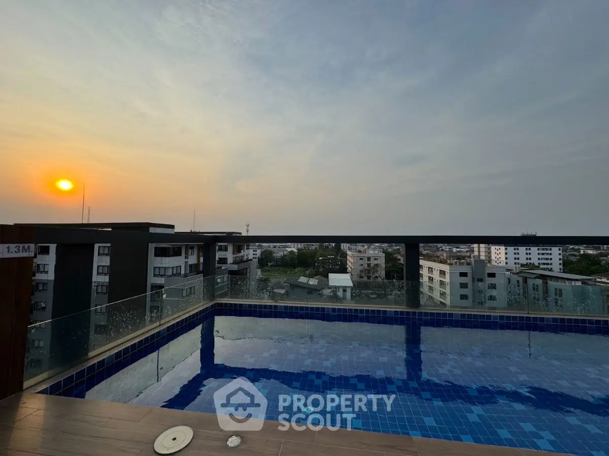 Stunning rooftop pool with panoramic city views at sunset, perfect for relaxation and leisure.