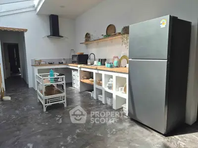 Spacious modern kitchen with sleek appliances and open shelving, perfect for culinary enthusiasts.