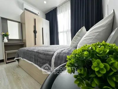 Modern bedroom with stylish decor and natural light, featuring a cozy bed and elegant furnishings.